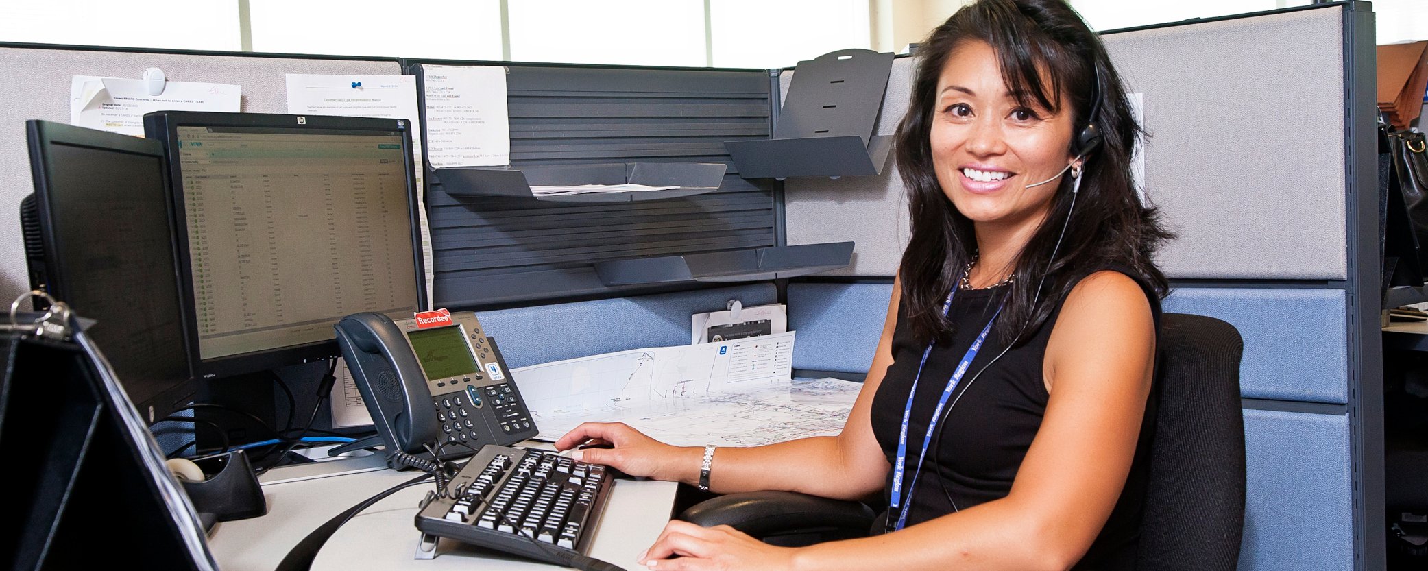 Photo of a Customer Service Rep posing in front of an office desk