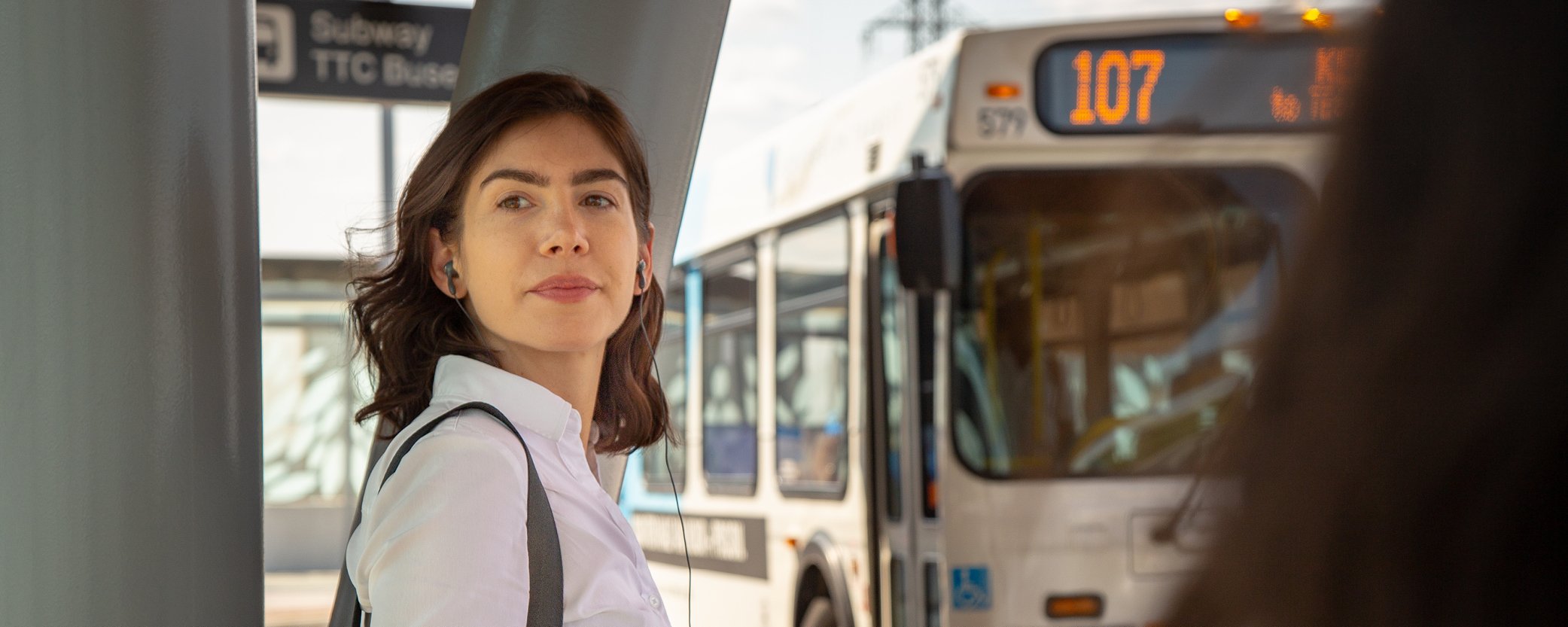 Image Banner of a woman waiting for the bus at bus stop