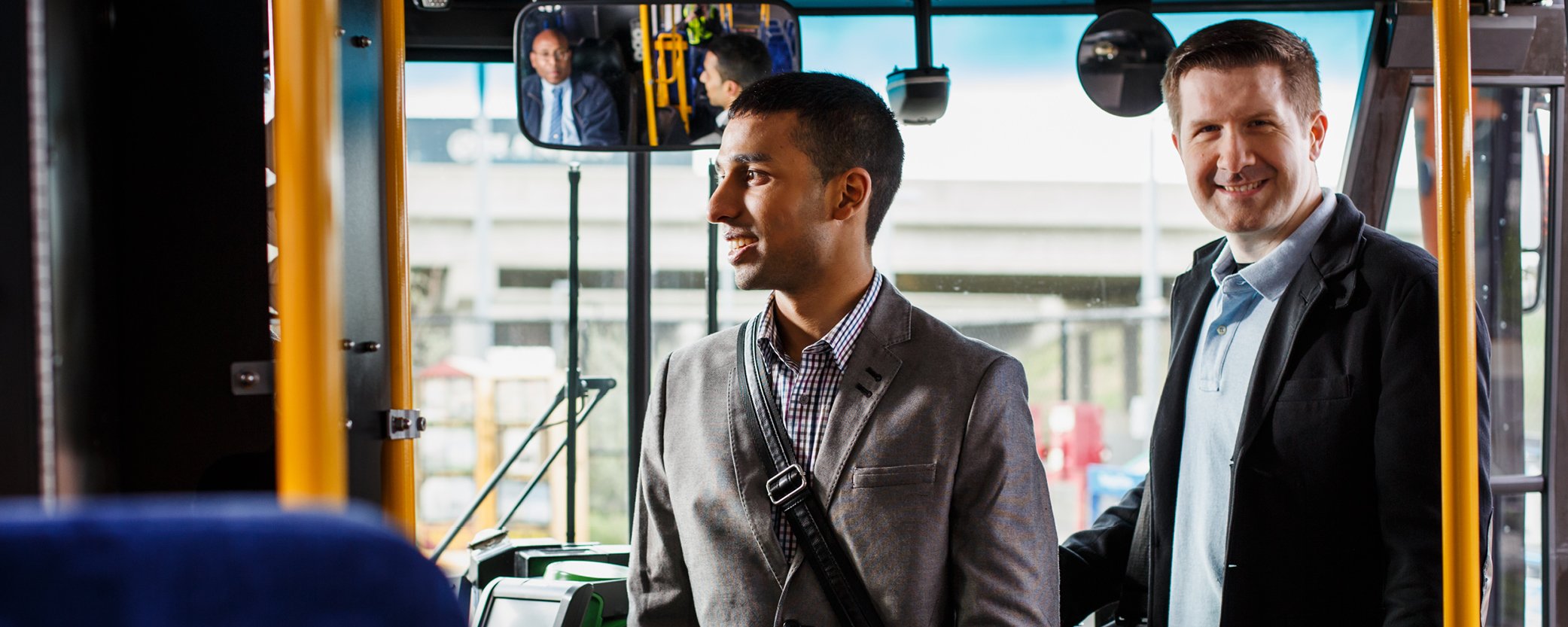 photo of two males in business clothing boarding bus