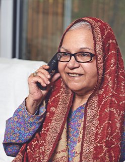 image of an elderly woman calling on a phone
