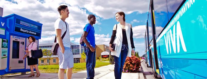 image of three adults waiting to board a bus