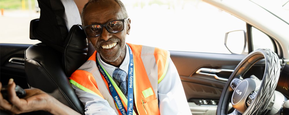 On-Request driver in a car smiling