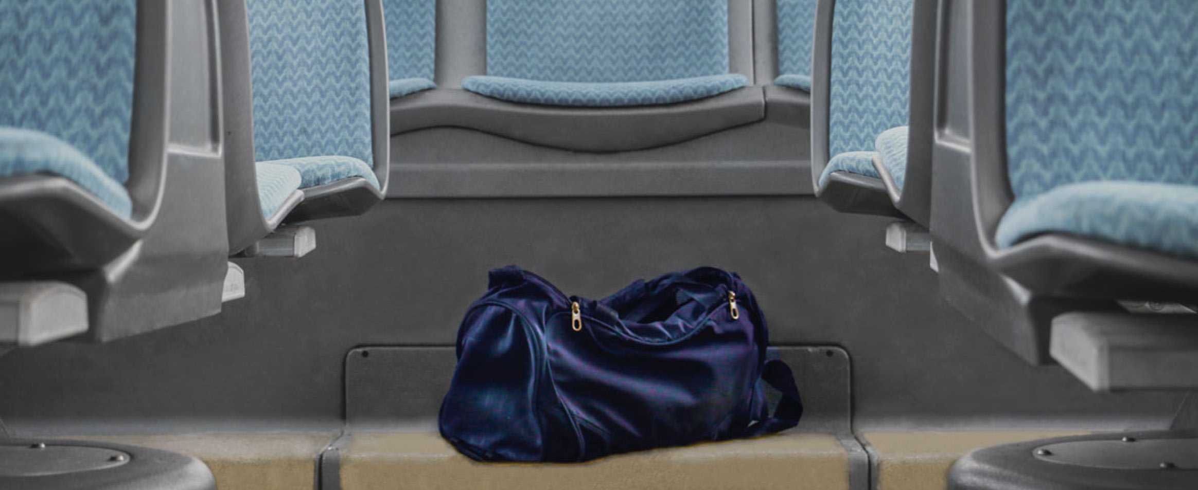 Blue duffle bag on the floor of a bus