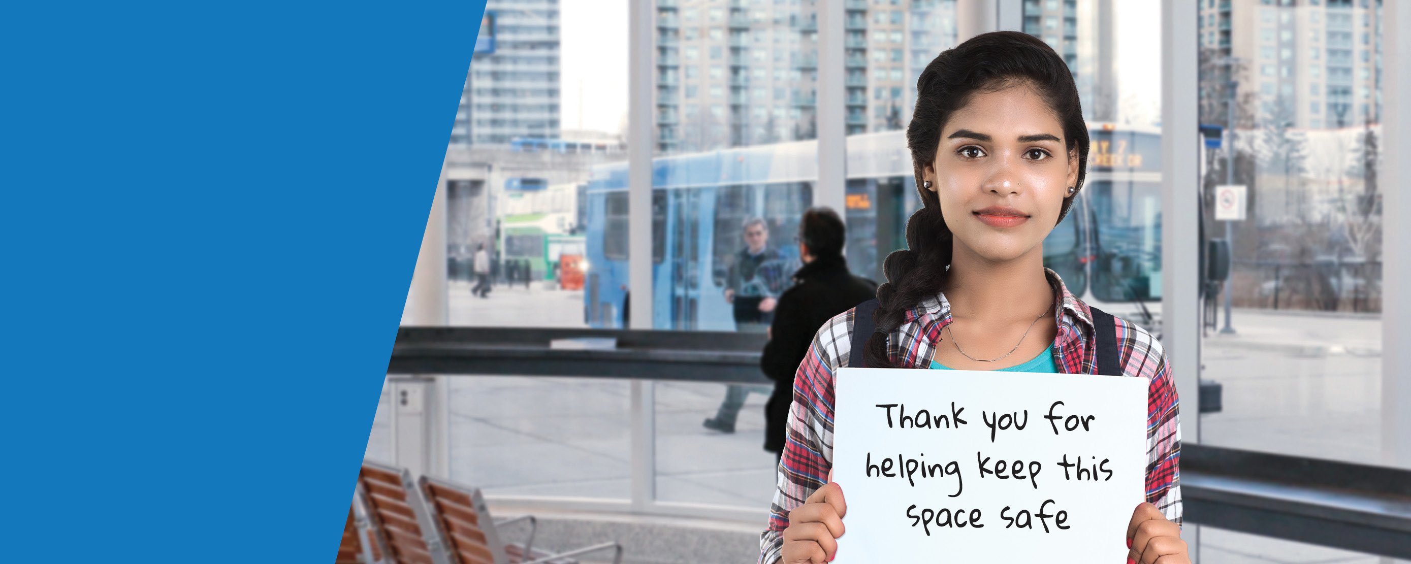 Female student holding up a sign saying "Thank you for helping keep this space safe"