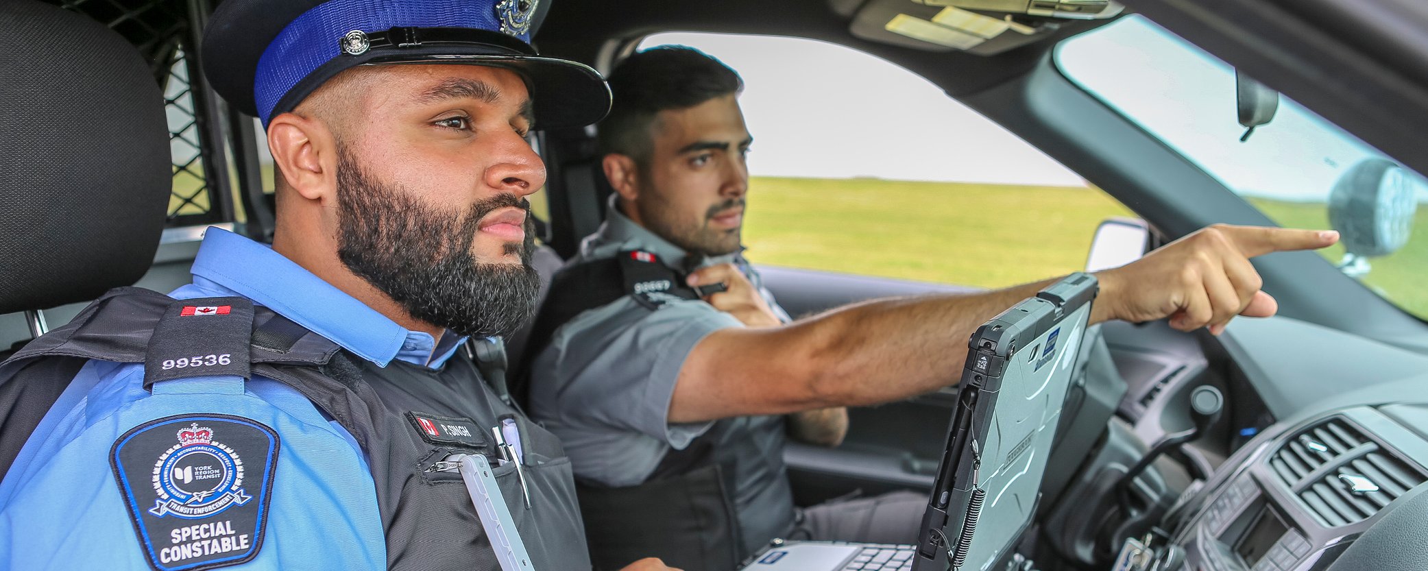 image of two transit enforcement officer inside a vehicle
